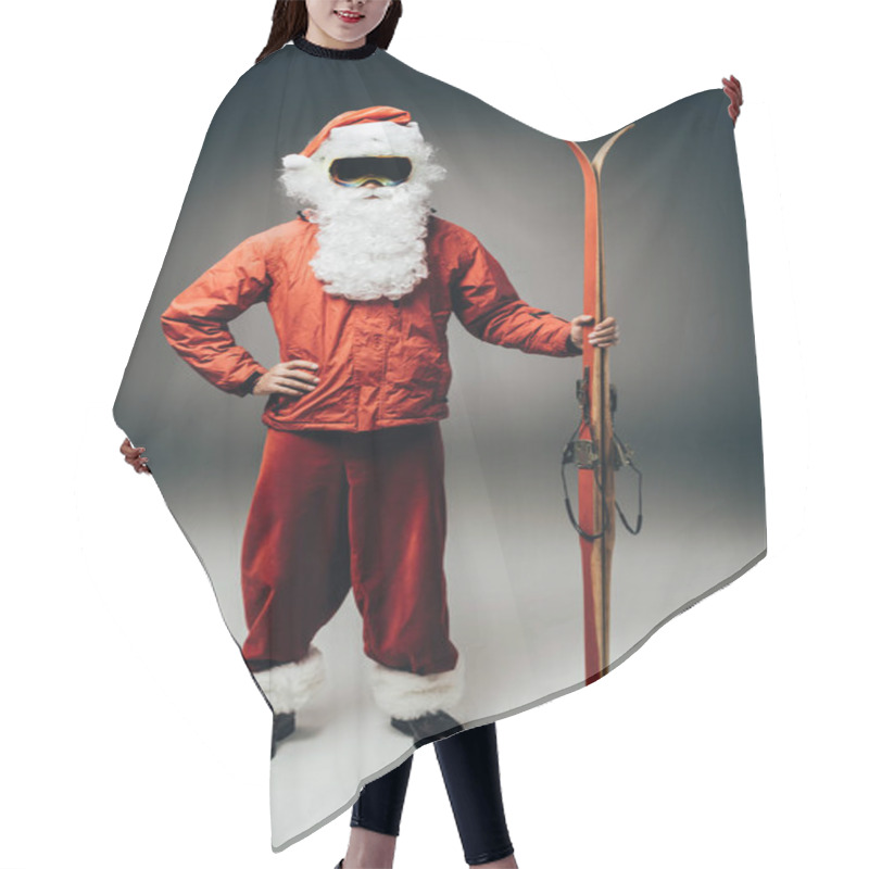 Personality  Serious Santa Claus In Ski Mask And Windbreaker Standing With Hand On Waist And Holding Skis On Grey Background  Hair Cutting Cape