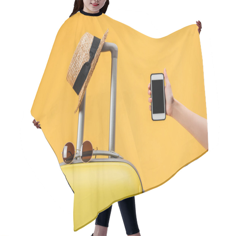 Personality  Cropped View Of Woman Holding Smartphone With Blank Screen Near Travel Bag, Straw Hat And Sunglasses Isolated On Yellow Hair Cutting Cape