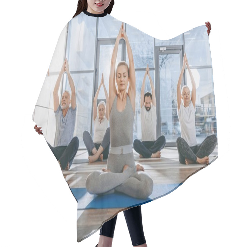 Personality  Group Of Senior People Practicing Yoga With Instructor In Lotus Pose On Mats In Studio Hair Cutting Cape