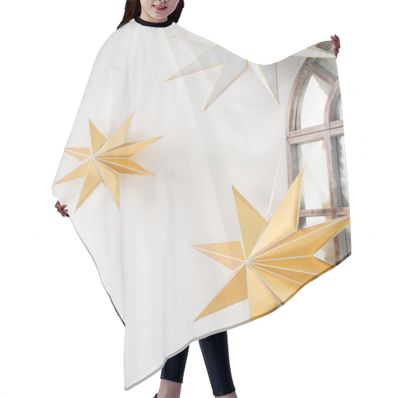 Personality  Golden And Silver Decorative Stars Hanging By A Window In A Cozy Interior, Creating A Warm Ambiance During The Holiday Season Hair Cutting Cape