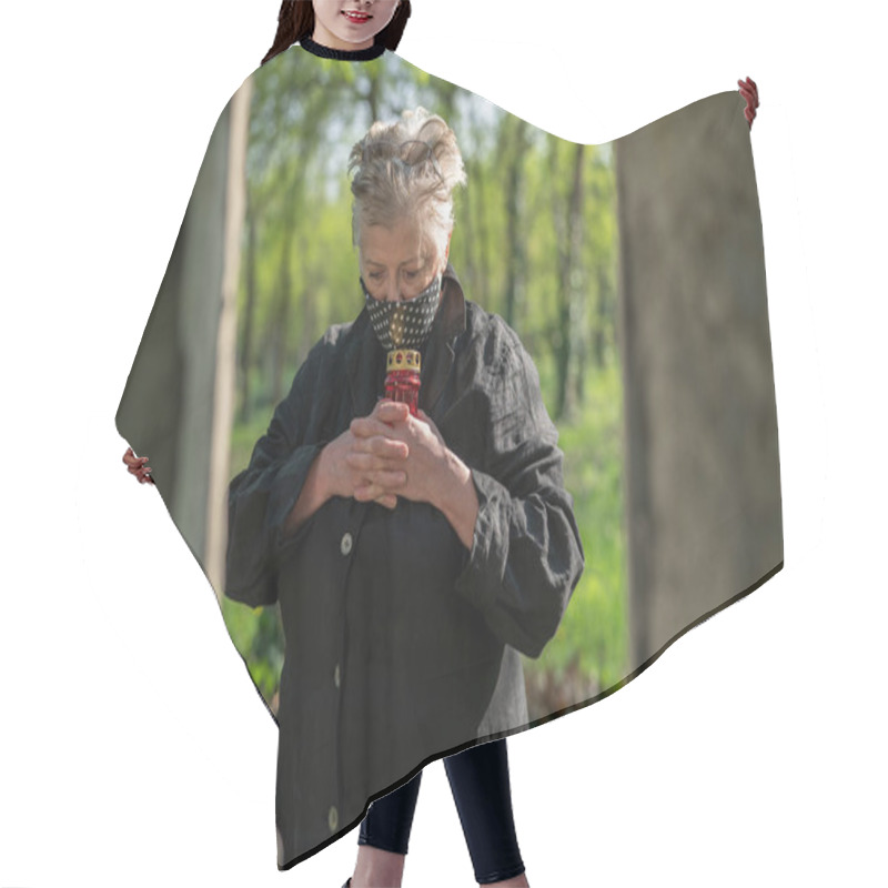 Personality  Senior Woman In Mask In A Cemetery Hair Cutting Cape