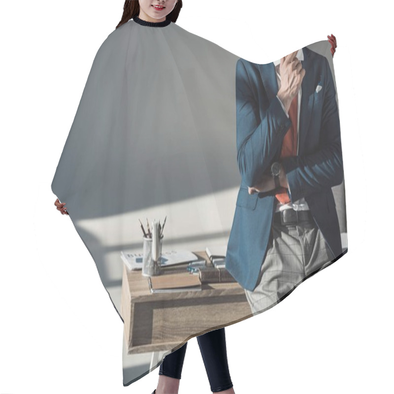 Personality  Cropped Shot Of Stylish Young Businessman With Hand In Chin Sitting On Table Hair Cutting Cape