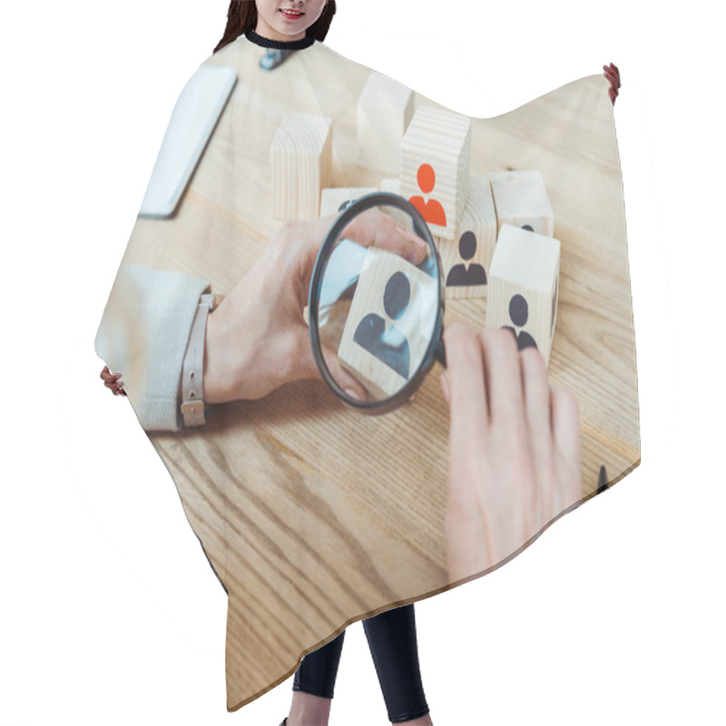 Personality  Cropped View Of Recruiter Holding Magnifier Near Wooden Cube  Hair Cutting Cape