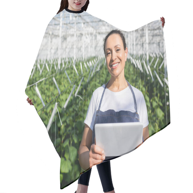 Personality  African American Farmer With Digital Tablet Smiling At Camera In Greenhouse Hair Cutting Cape