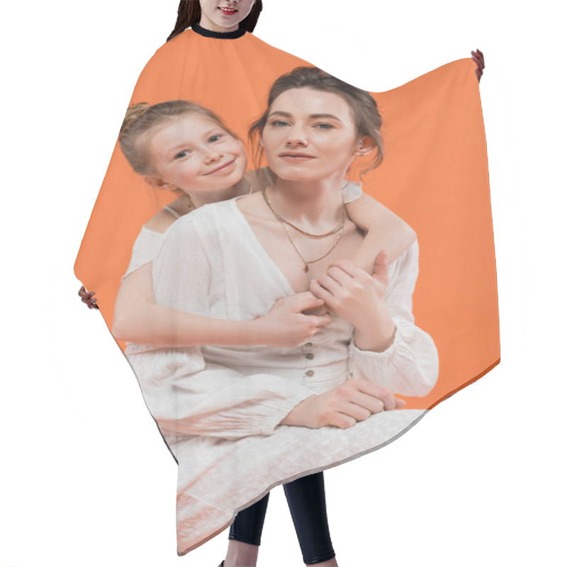 Personality  Mother And Daughter, Happy Preteen Girl Hugging Young Woman On Orange Background, White Sun Dresses, Modern Parenting, Summer Fashion, Togetherness, Love, Fashionable Family  Hair Cutting Cape