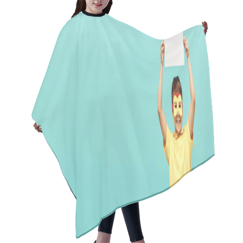 Personality  Carefree Multiracial Boy In Yellow Superhero Costume With Mask Holding Blank Paper Above Head On Blue Background, Happy Children's Day Concept, Banner Hair Cutting Cape