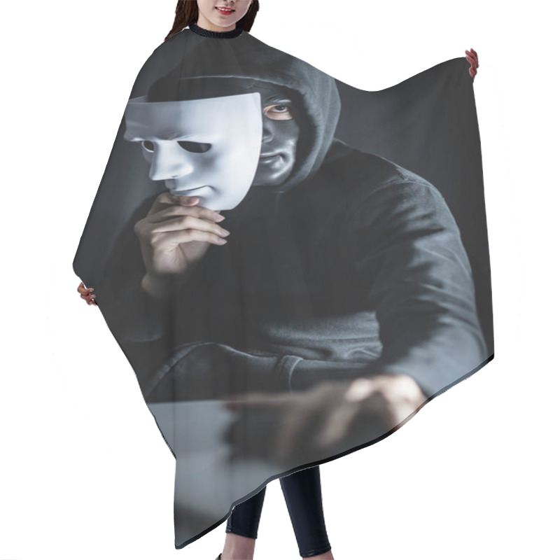 Personality  Mystery Male Hoodie Hacker Wearing Black Mask Holding White Mask With Gun And Laptop Computer On The Table. Anonymous Social Masking. Ransomware Cyber Attack Or Internet Security Concepts Hair Cutting Cape