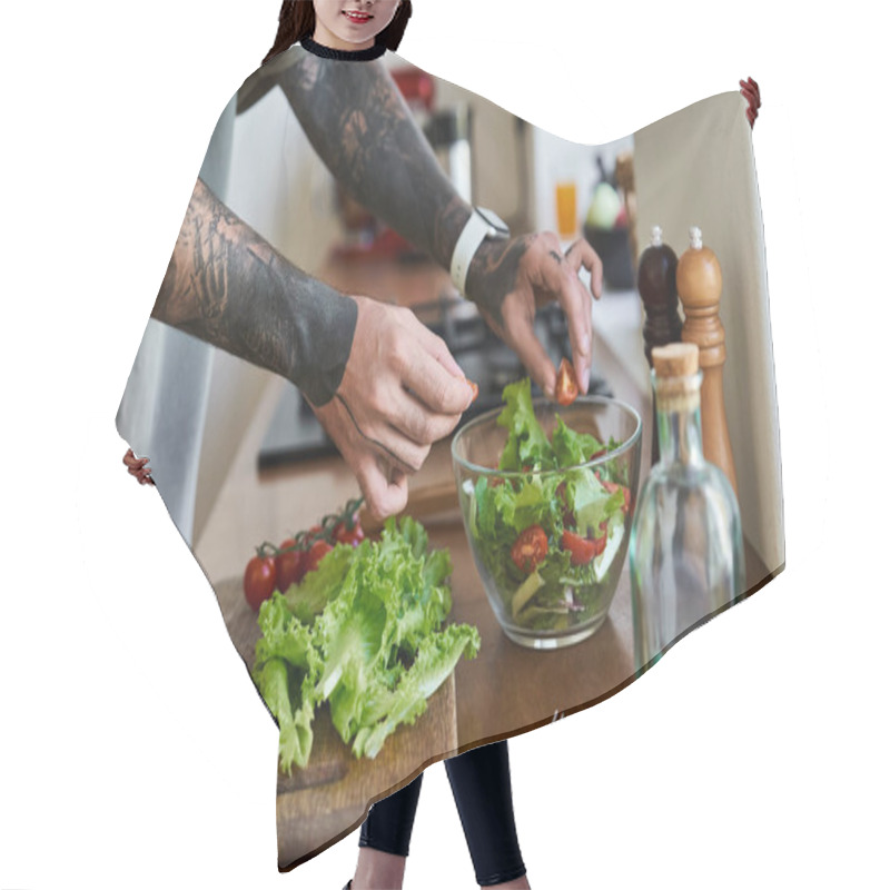 Personality  A Young Man Enjoys Cooking, Skillfully Assembling A Bright And Healthy Salad In A Kitchen. Hair Cutting Cape