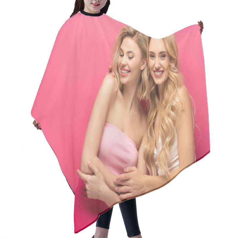 Personality  Smiling Blonde Girl Embracing Friend And Looking At Camera On Pink Background Hair Cutting Cape