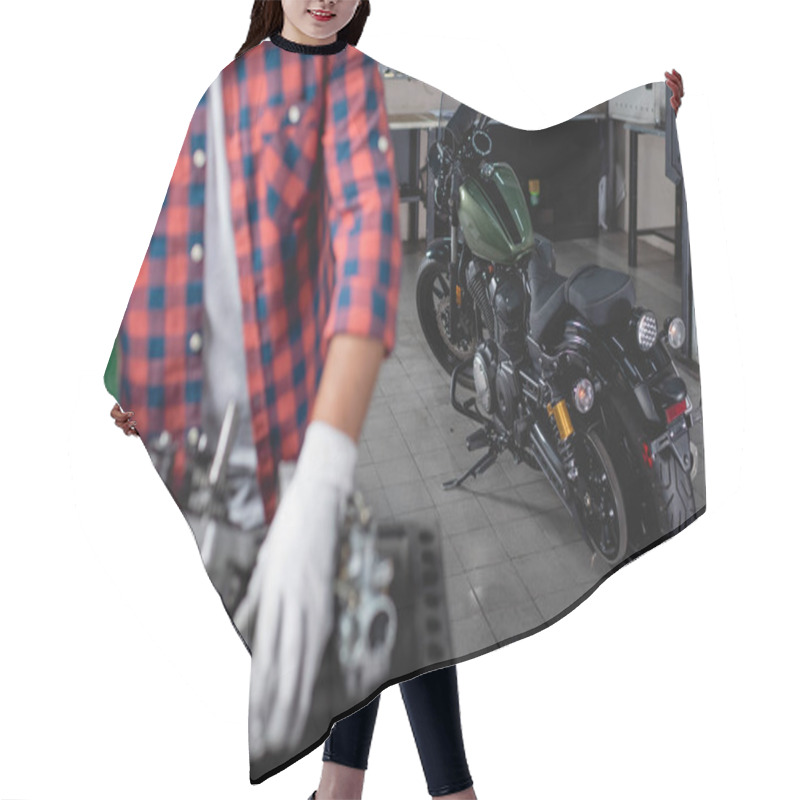 Personality  Selective Focus Of Motorcycle Near Mechanic And Disassembled Gearbox On Blurred Foreground Hair Cutting Cape