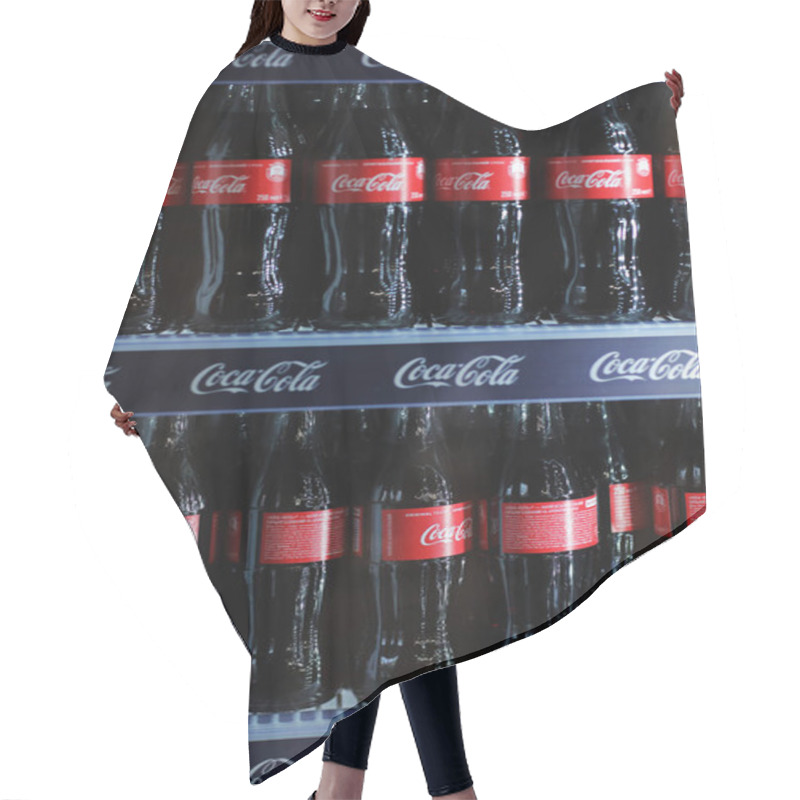 Personality  Rivne, Ukraine - 18 February 2020: Bottles Of Coca Cola Drink When In A Mini Fridge. Hair Cutting Cape