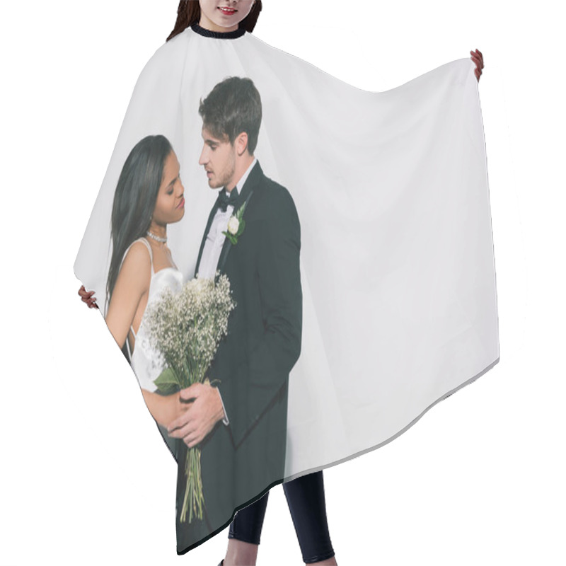 Personality  Handsome Bridegroom And Attractive African American Bride With Wedding Bouquet Standing Face To Face On White Background Hair Cutting Cape