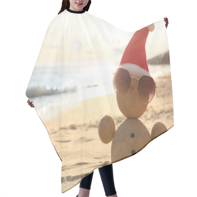 Personality  Snowman Made Of Sand With Santa Hat And Sunglasses On Beach Near Sea, Space For Text. Christmas Vacation Hair Cutting Cape