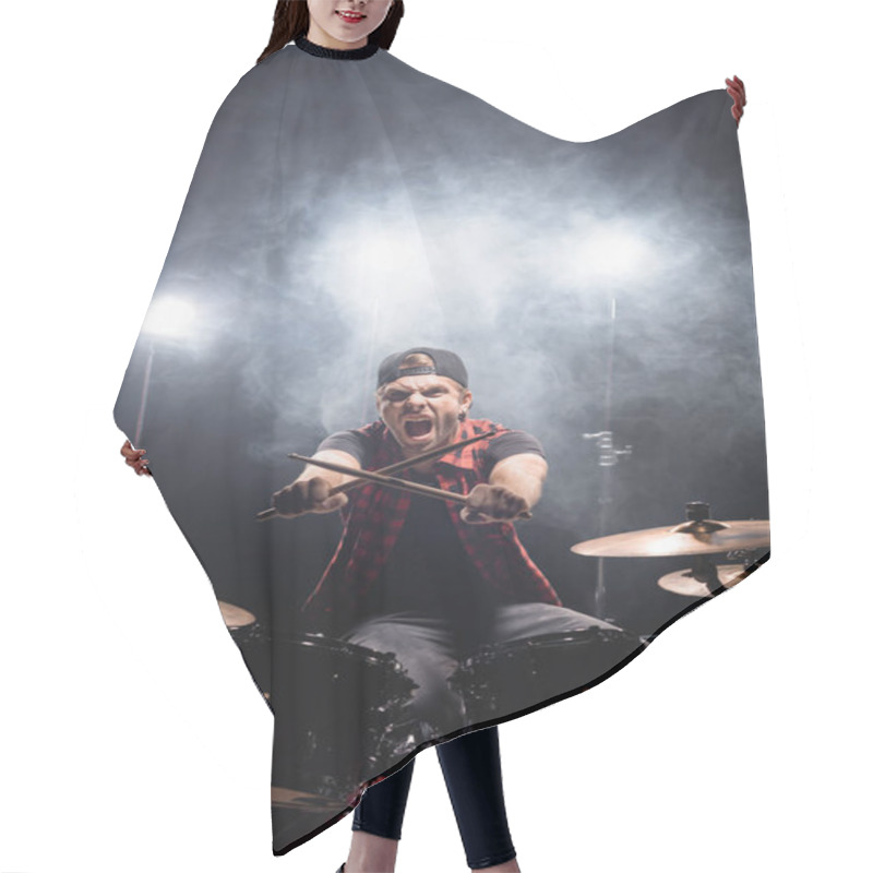 Personality  Screaming Drummer With Crossed Drumsticks Looking At Camera, While Sitting At Drum Kit With Smoke And Backlit On Background Hair Cutting Cape