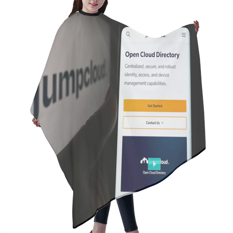 Personality  Stuttgart, Germany - 05-27-2024: Person Holding Cellphone With Webpage Of US Cloud Software Company JumpCloud Inc. In Front Of Business Logo. Focus On Center Of Phone Display. Hair Cutting Cape