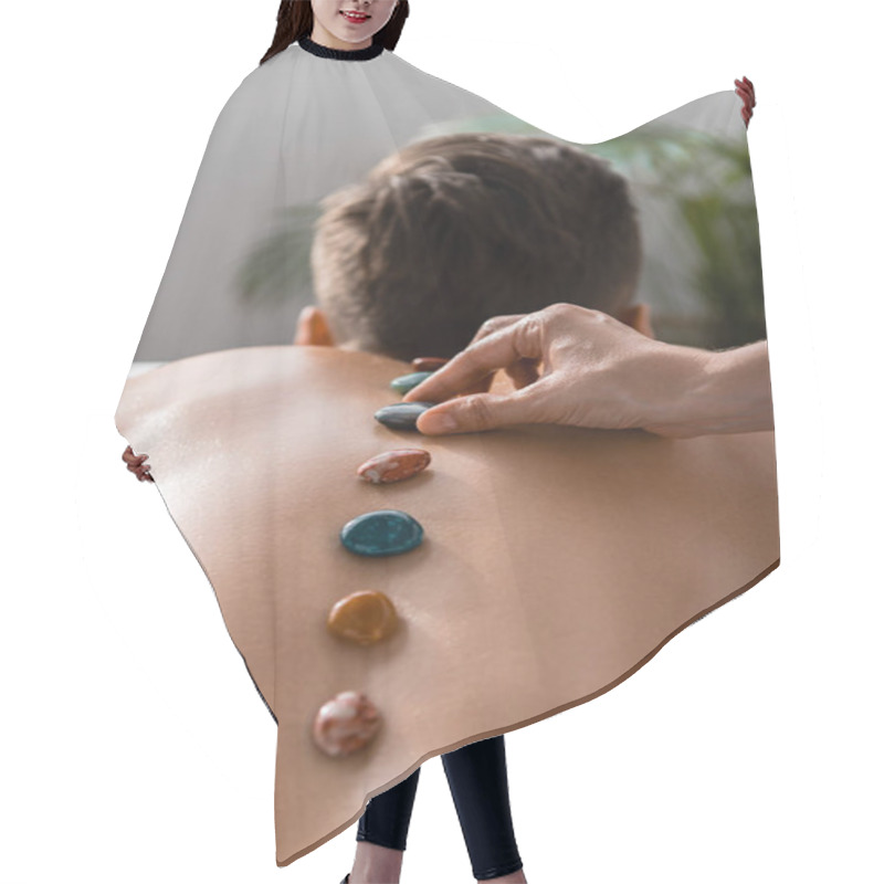 Personality  Cropped View Of Masseur And Shirtless Man With Stones On Back Hair Cutting Cape