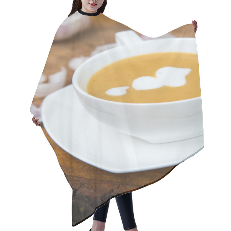 Personality  Garlic Cream Soup In Orange Bowl On Wooden Background. Rustic Country Style. Hair Cutting Cape