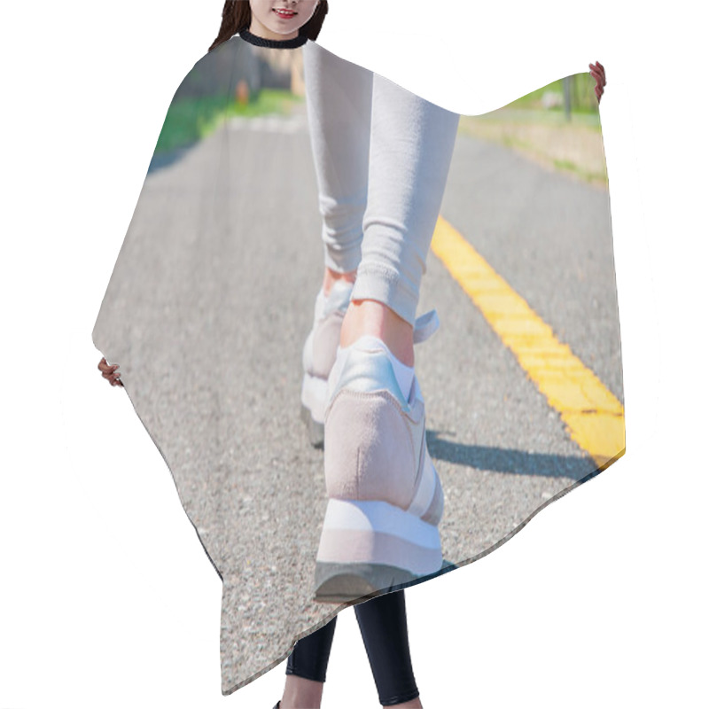 Personality  Walking. Close-up Of Women's Running Shoes On A Paved Trail. Female Feet In Sneakers. Hair Cutting Cape