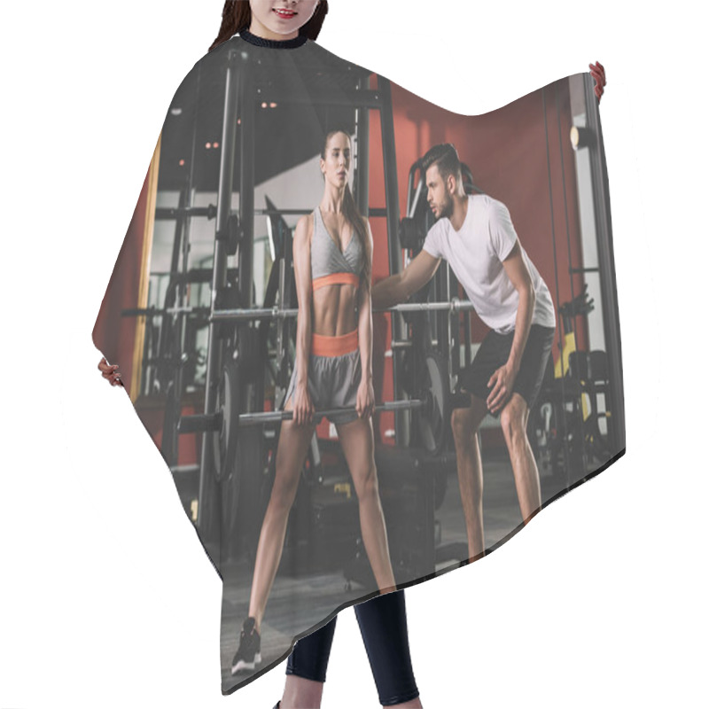 Personality  Handsome Trainer Supporting Attractive Sportswoman Lifting Barbell Hair Cutting Cape