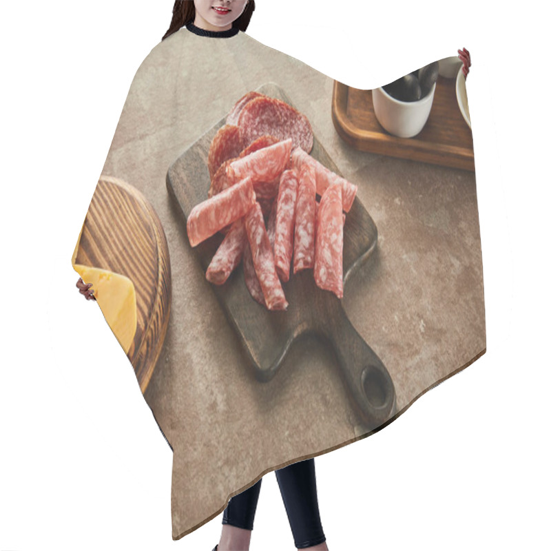 Personality  High Angle View Of Boards With Salami Slices, Bowl With Olives And Cheese On Brown Hair Cutting Cape