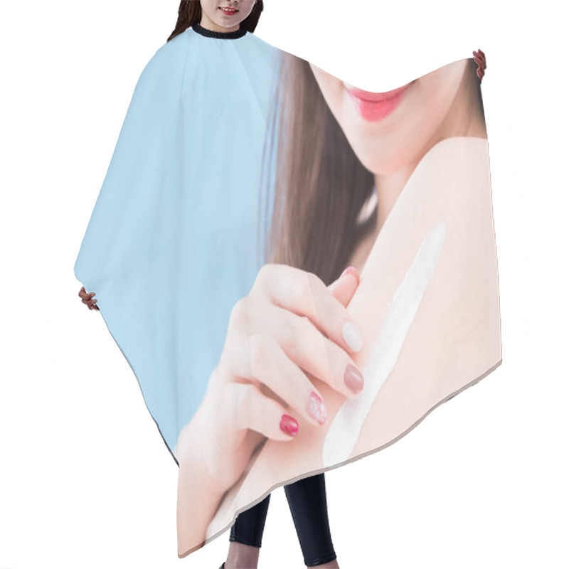 Personality  Woman Applying  Sunscreen On The Blue Background Hair Cutting Cape