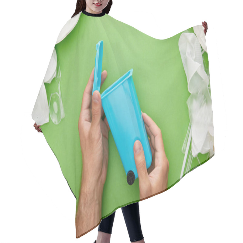 Personality  Cropped View Of Man Holding Blue Recycle Bin Near Crumpled Plastic Cups On Blue Background Hair Cutting Cape