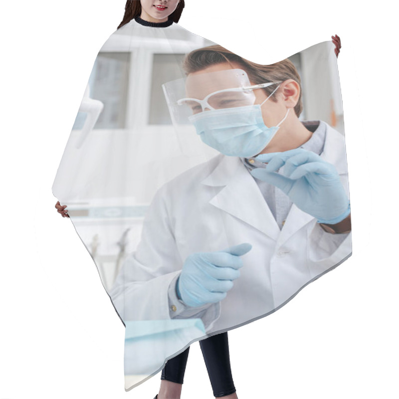 Personality  Selective Focus Of Dentist In Medical Mask, Face Shield And Latex Gloves Holding Dental Instrument Near African American Woman  Hair Cutting Cape