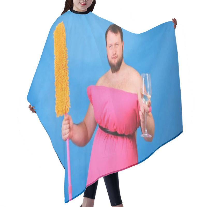 Personality  Funny Bearded Guy In A Pink Pillow Dress With A Mop And A Glass Of Wine On A Blue Background. Crazy Quarantine. Funny House Cleaning. Fashion 2020. Put On A Pillow. Challenge 2020 Due To House Hair Cutting Cape