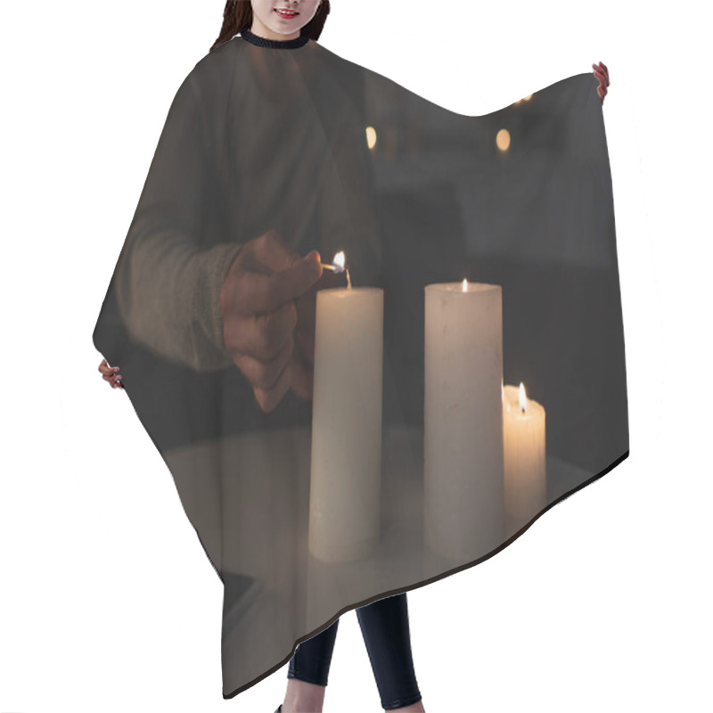 Personality  Cropped View Of Man In Darkness Lighting Candle With Burning Match Near Smartphone With Blank Screen Hair Cutting Cape