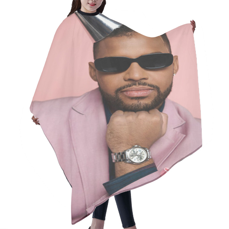 Personality  A Joyful Young African American Man In Braces, Wearing A Pink Suit And A Party Hat, Stands Against A Vibrant Pink Background. Hair Cutting Cape