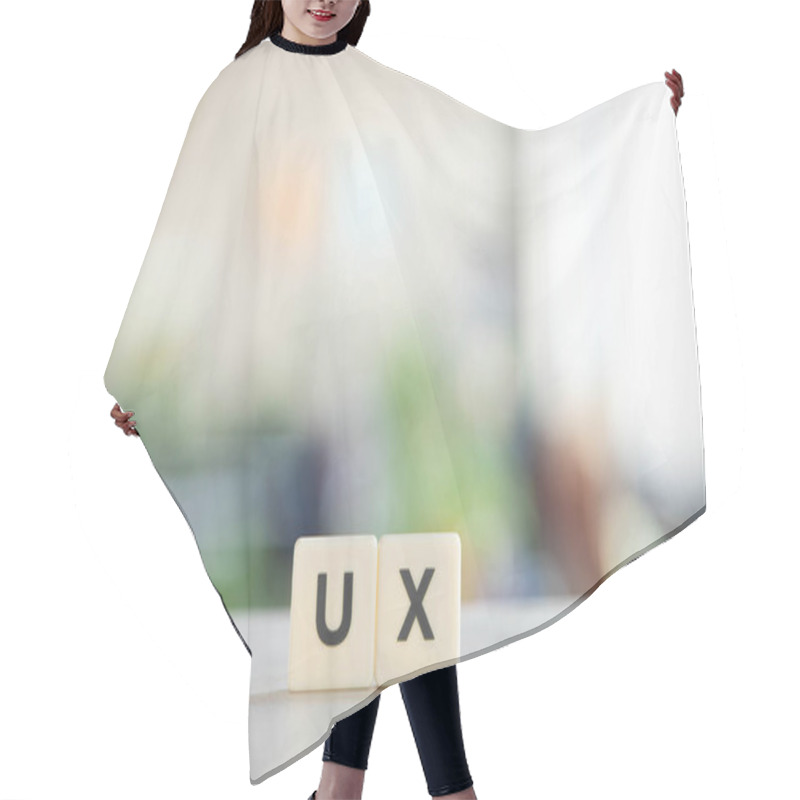 Personality  White Blocks With Ux Lettering On Office Desk  Hair Cutting Cape