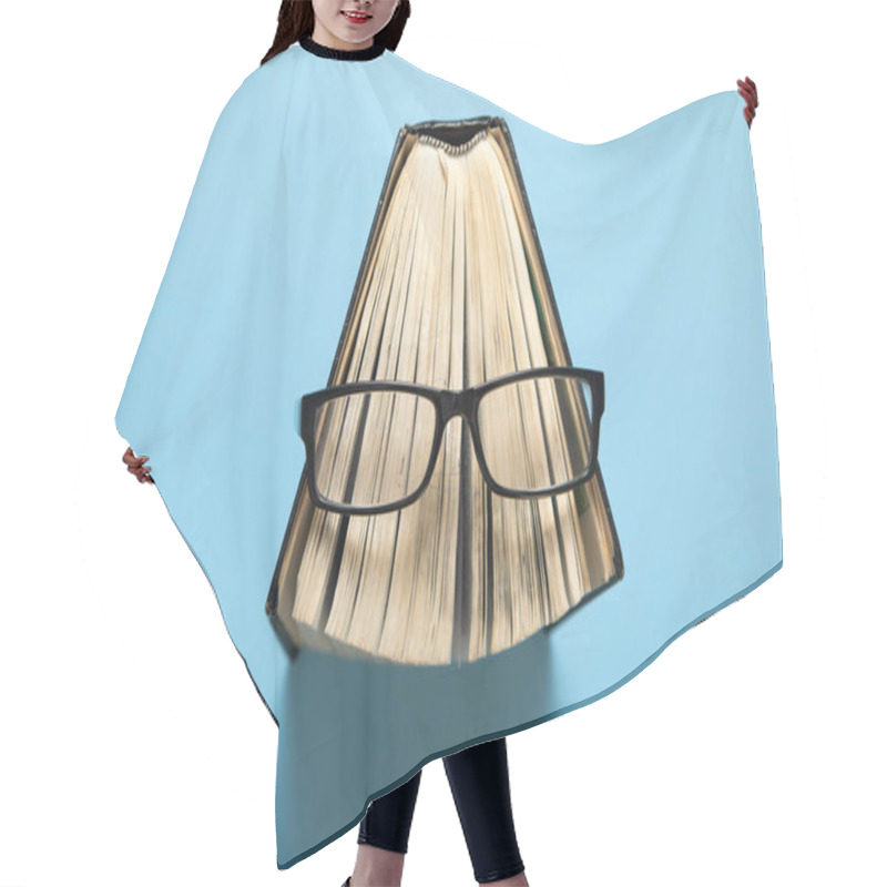 Personality  Eyeglasses And Book On The Blue Background. Hair Cutting Cape