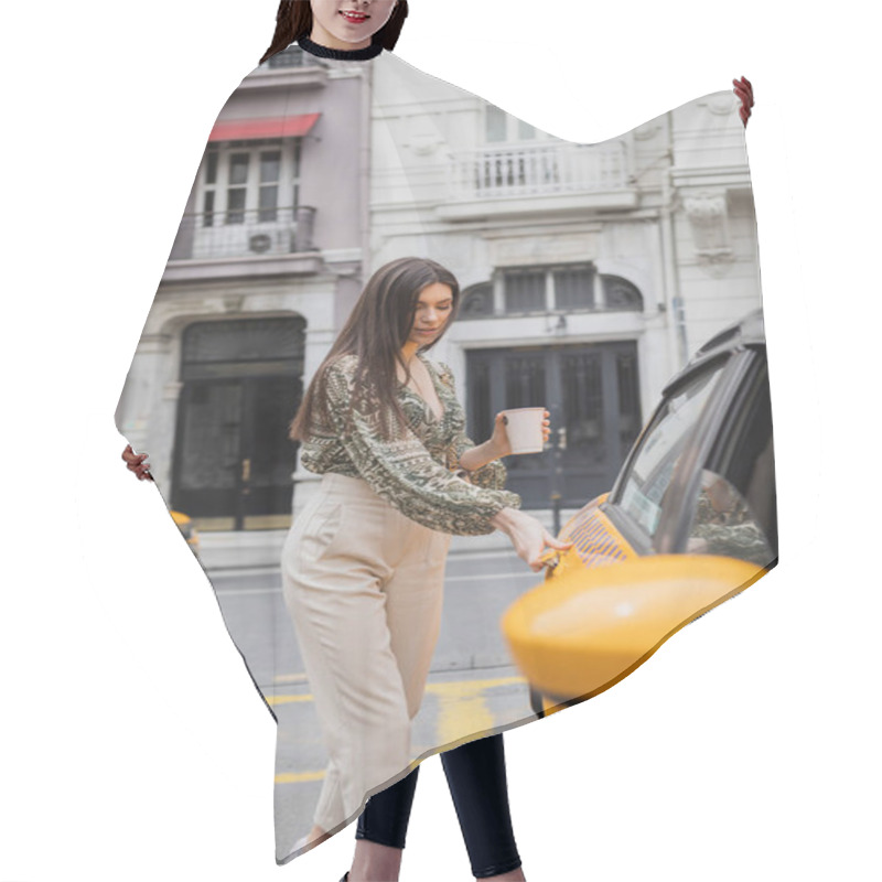 Personality  Attractive Woman With Long Hair Holding Coffee In Paper Cup While Standing In Trendy Outfit With Handbag And Opening Door Of Yellow Cab On Blurred Urban Street With Building In Istanbul  Hair Cutting Cape