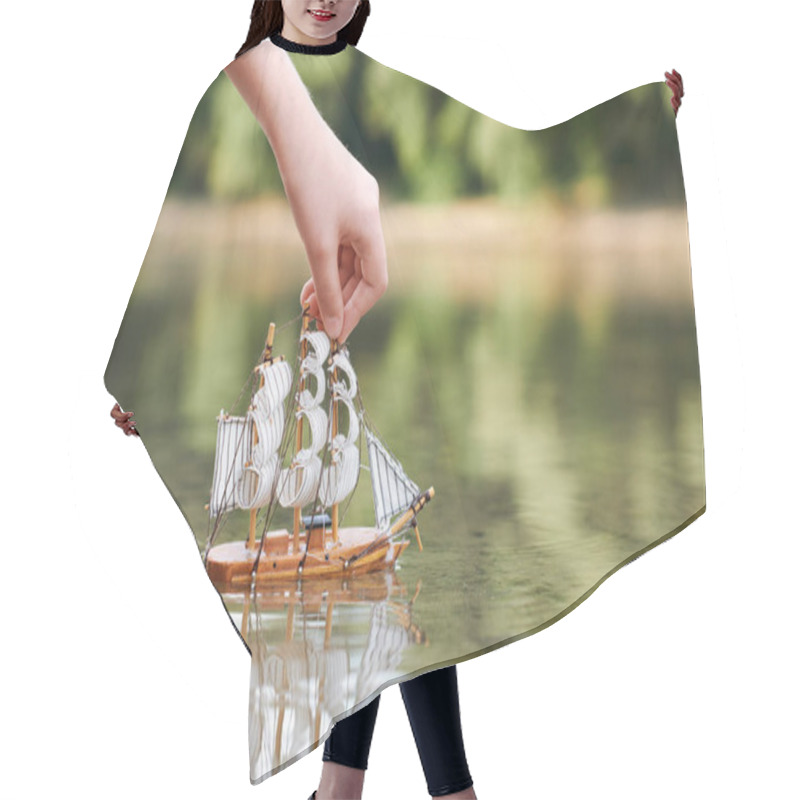 Personality  Girl Playing With A Toy Sailing Ship By The River, Hand Closeup Hair Cutting Cape