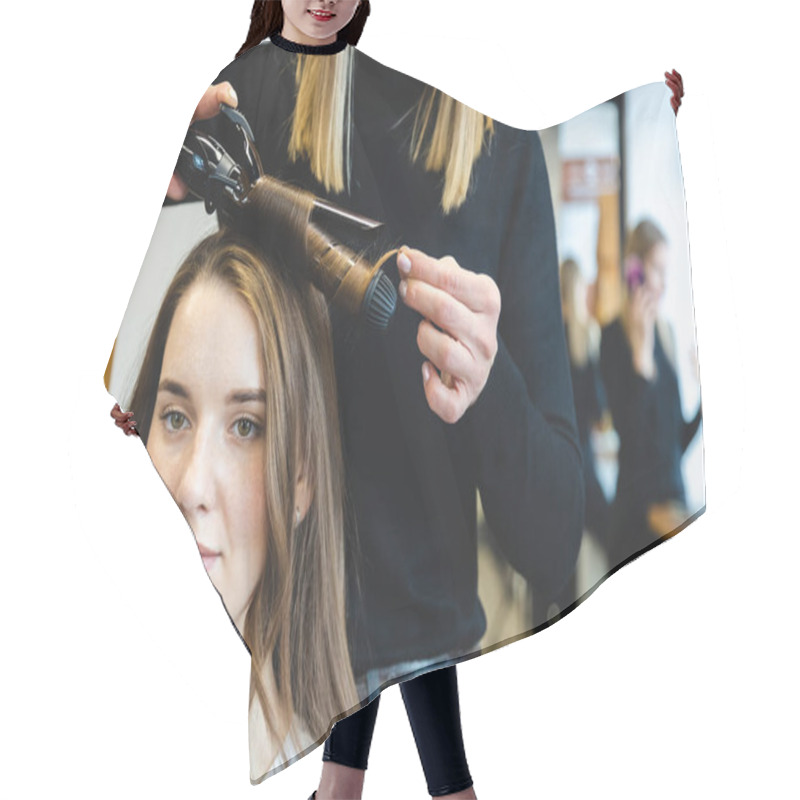 Personality  Master Woman Hairdresser Gently Curls Hair Curling Girl In A Beauty Salon. Hair Styling Hair Cutting Cape