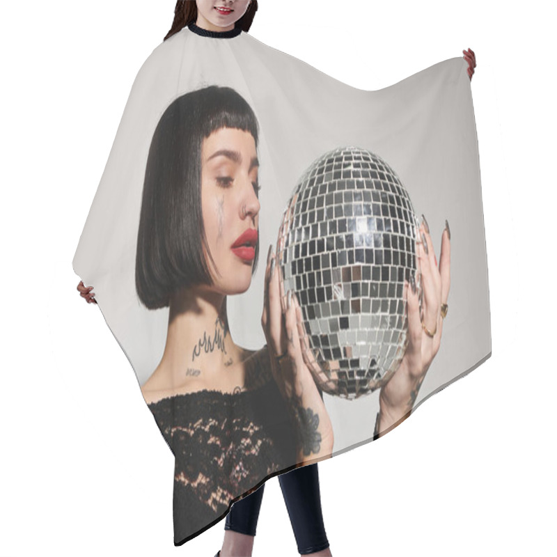 Personality  Stylish Woman With Tattoos Showcases A Sparkling Disco Ball In A Chic Environment. Hair Cutting Cape