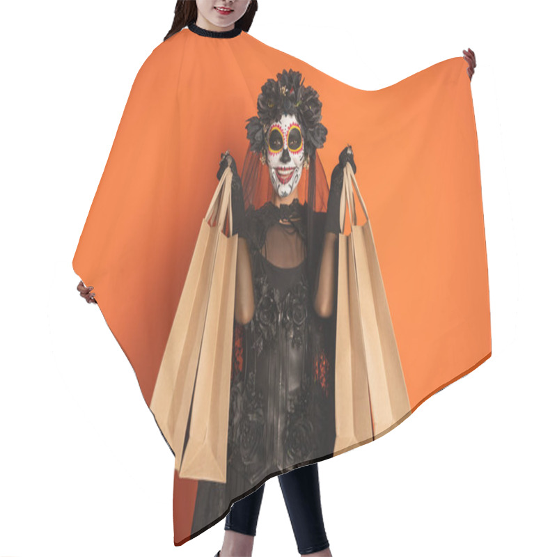 Personality  Cheerful Woman In Black Witch Costume And Halloween Makeup Showing Shopping Bags Isolated On Orange Hair Cutting Cape