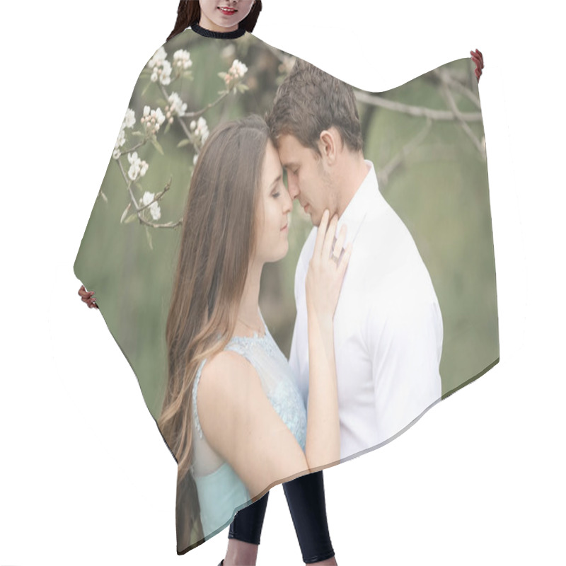 Personality  Kissing Newlywed Couple Is Spending Time In The Blooming Garden. Hair Cutting Cape