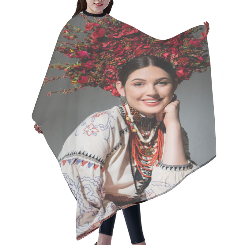 Personality  Portrait Of Happy Ukrainian Woman In Traditional Clothing And Floral Red Wreath Isolated On Grey Hair Cutting Cape