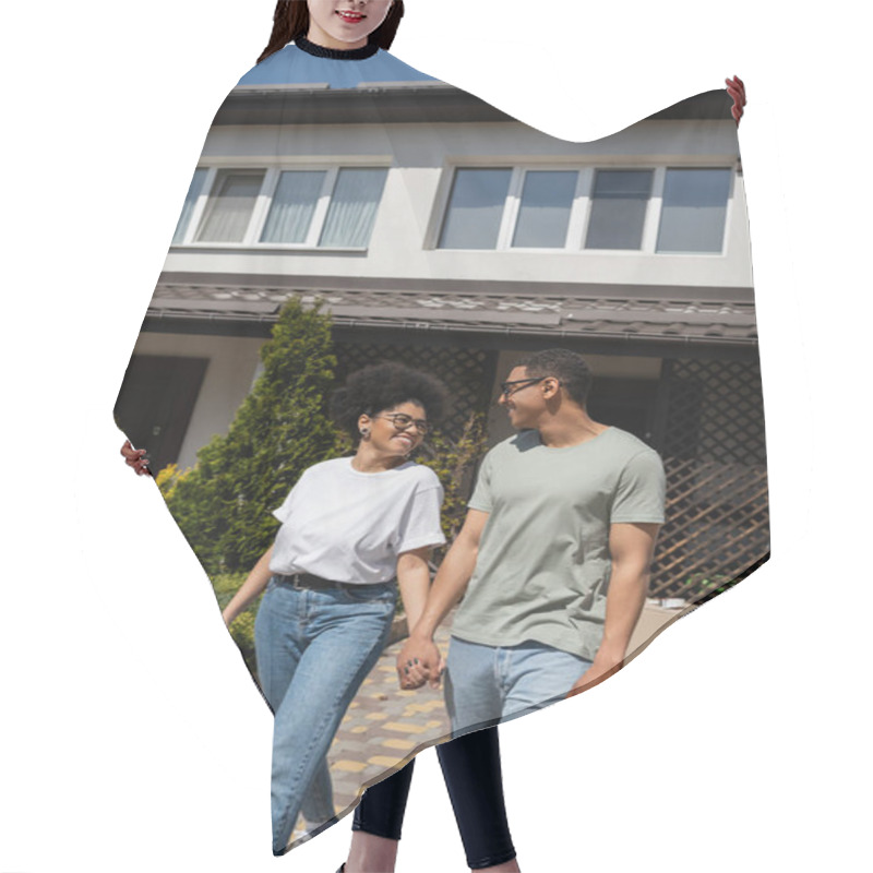 Personality  Happy African American Couple Holding Hands While Standing Near New House On Background Hair Cutting Cape