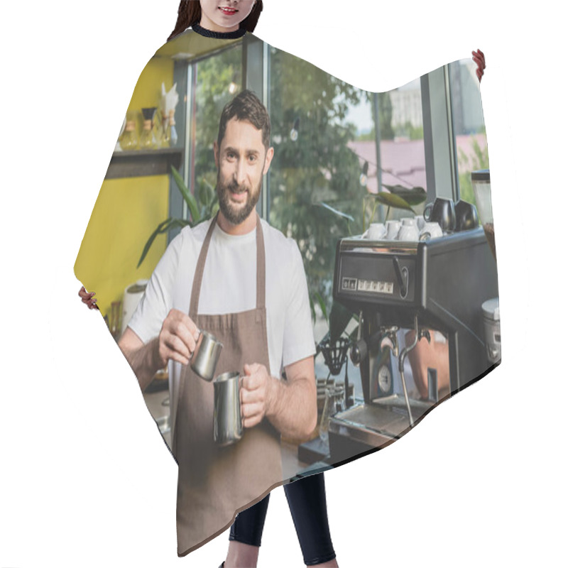 Personality  Cheerful Bearded Barista In Apron Holding Pitchers Near Coffee Machine In Coffee Shop Hair Cutting Cape