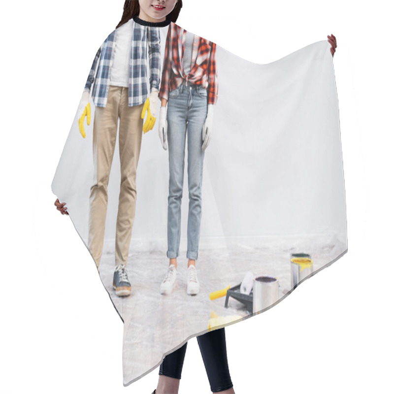 Personality  Cropped View Of Young Couple In Gloves Standing Near Tins Of Paint, Rollers And Tray On Floor Covered With Polyethylene  Hair Cutting Cape