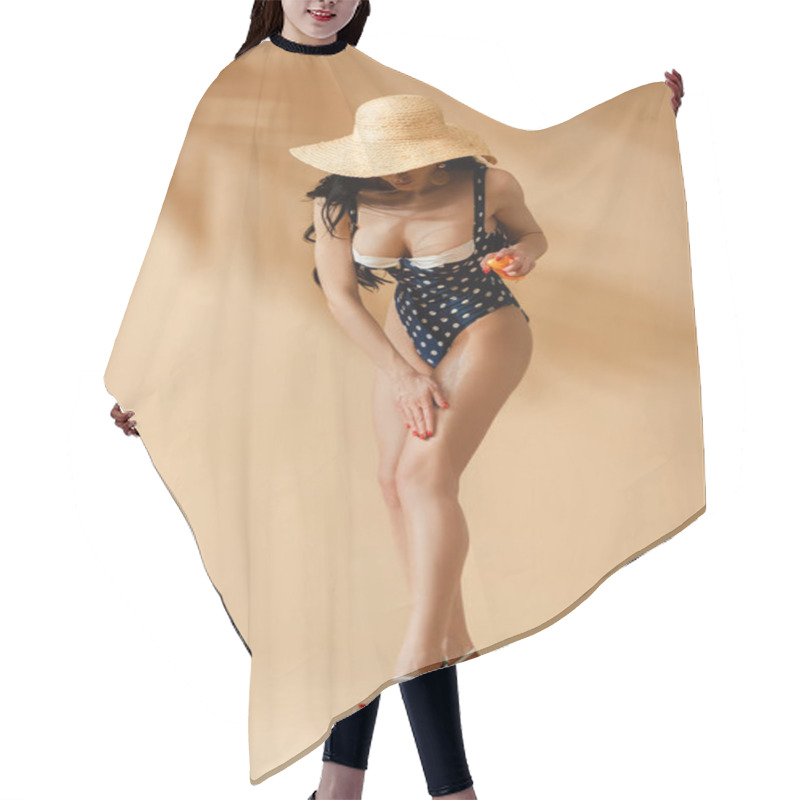 Personality  Sexy Brunette Woman In Polka Dot Swimsuit And Straw Hat Applying Sunscreen On Beige Background Hair Cutting Cape