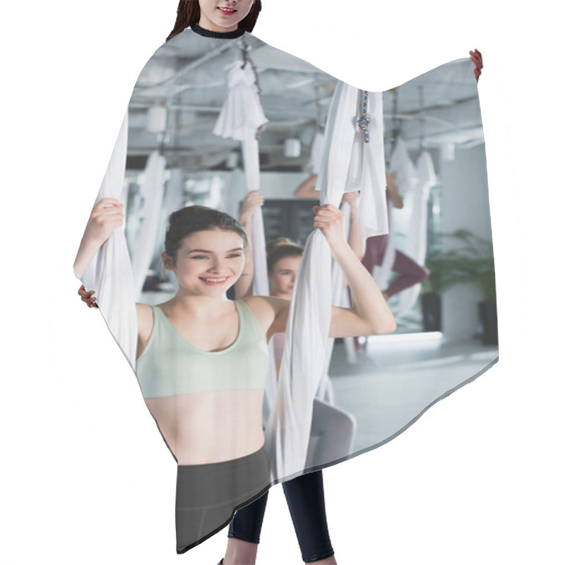 Personality  Cheerful Woman Exercising With Fly Yoga Hammock On Blurred Background Hair Cutting Cape