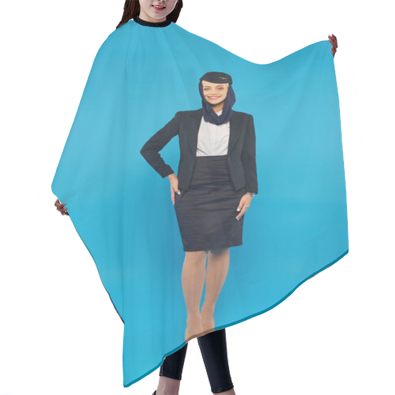 Personality  Young Woman In Arabian Airlines Uniform And Headscarf Posing With Hand On Hip On Blue, Full Length Hair Cutting Cape