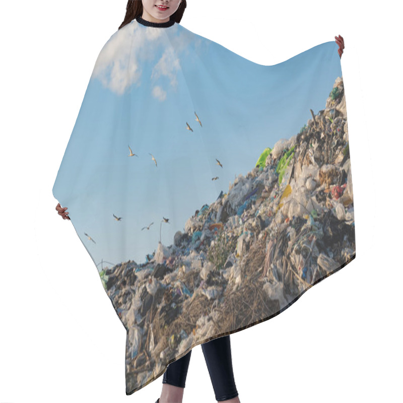 Personality  A Large Mountainous Heap Of Trash Dominates The Landscape At A Landfill, While Several Birds Soar Overhead Against A Backdrop Of A Bright Blue Sky. Hair Cutting Cape