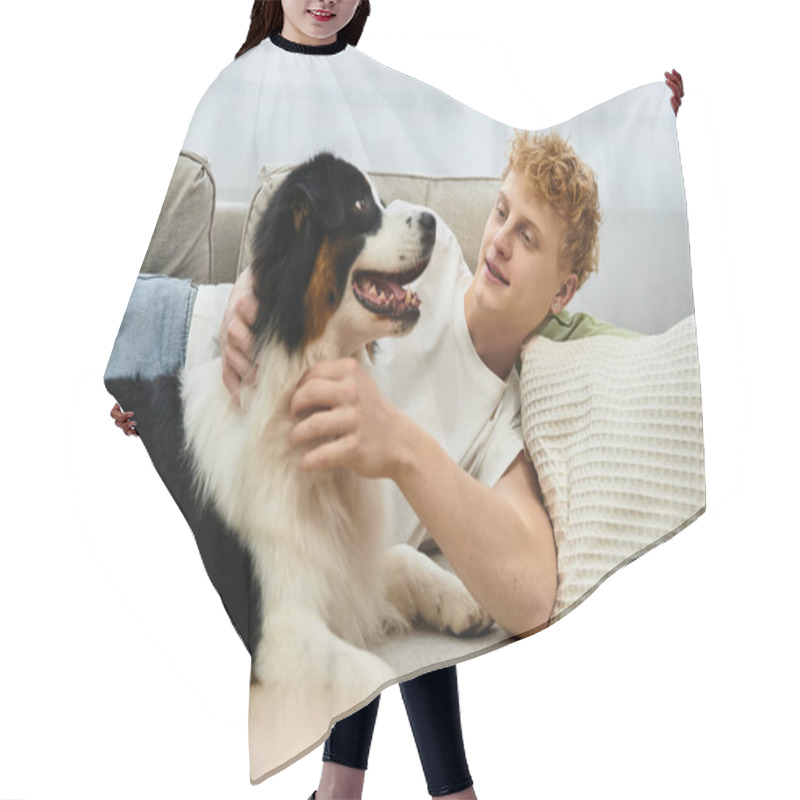 Personality  A Cheerful Redhead Man Interacts Lovingly With His Sweet Australian Shepherd Dog At Home. Hair Cutting Cape