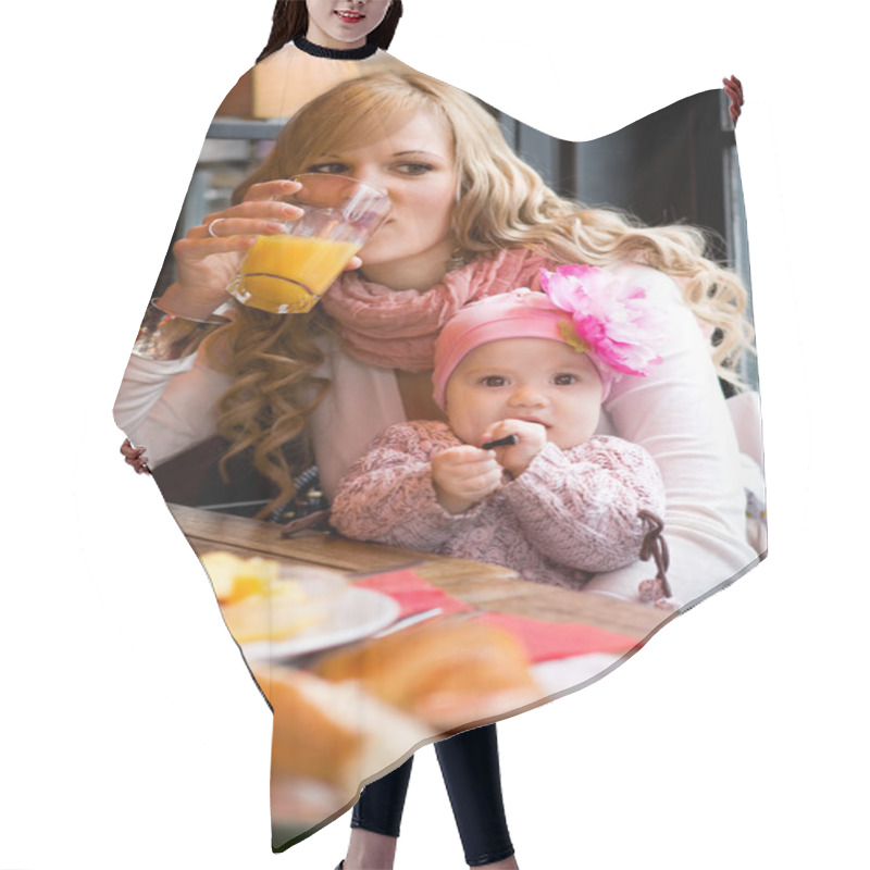 Personality  Young Mother And Baby Daughter Having Breakfast Together In A Pa Hair Cutting Cape