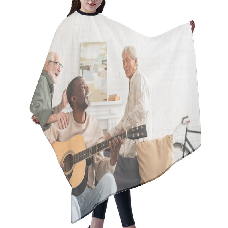 Personality  African American Man Playing Acoustic Guitar Near Multiethnic Friends In Living Room  Hair Cutting Cape