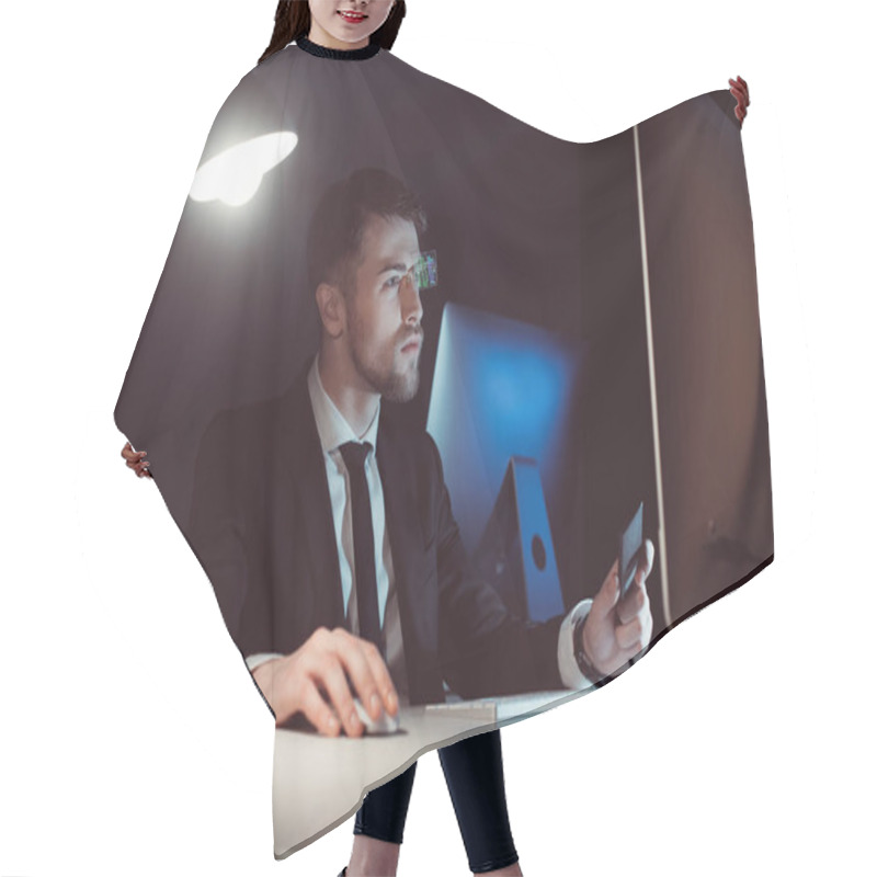 Personality  Portrait Of Hacker Looking At Computer Screen At Table In Dark Hair Cutting Cape